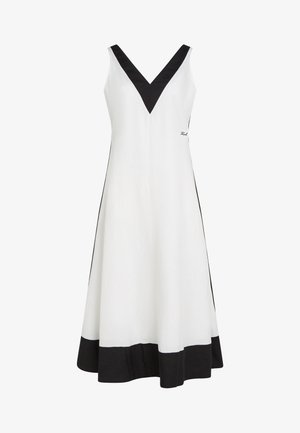 Bjela haljina bez rukava s crnim V-izrezom, crnim obrubom na rubu i prilagođenim A-linijskim krojem.