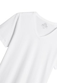 Tricou alb din bumbac, cu guler în V și mâneci scurte. Textură netedă, croială standard, etichetat "tricou din bumbac Next" în guler.