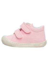 Pink canvas shoe with double Velcro straps, round toe, and textured rubber sole. Features a padded collar and contrasting white trim.