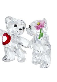 Två kristallbjörnar: en håller ett rött hjärta, den andra har en rosa blommma. Båda har fasetterade ytor och svarta ögon.