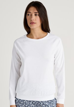 White long-sleeve sweatshirt with a crew neck, featuring ribbed cuffs and hem. Soft, smooth fabric with a relaxed fit.