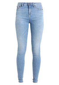 Ljusblå skinny jeans av denim, med hög midja, femfickorsdesign, dekorativ sömnad och en lätt urtvättad yta.
