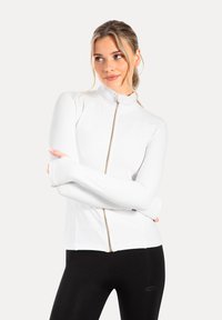 White zip-up jacket with a high collar and fitted long sleeves; features stretchy fabric and a gold zipper accent; smooth texture.