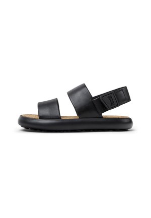 Sandalias de cuero negro con dos correas anchas, una plantilla de corcho y una suela de goma negra que presenta pequeños puntos elevados para mayor tracción.