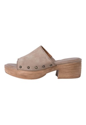 Beige suede slide sandal with a rounded open toe, brown accent, and textured heel. Features round metallic studs along the side.