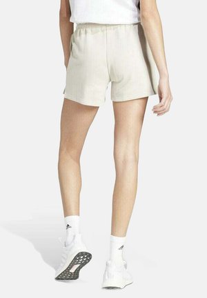 Pantalones cortos deportivos de color beige claro con una cintura elástica y bolsillos laterales. Textura suave, diseñados para brindar comodidad y facilidad de movimiento.