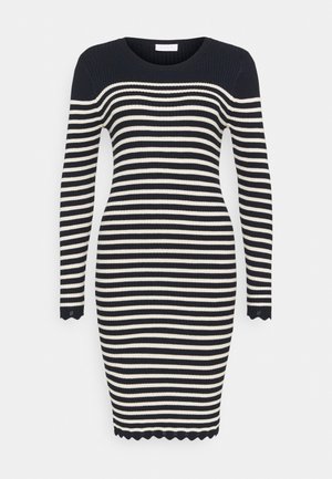 Robe en maille à manches longues, longueur genou, avec des rayures horizontales noires et blanches et des bords festonnés aux poignets et à l'ourlet.