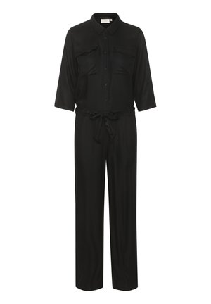 Melnas kombinezons, kas izgatavots no gludas auduma, ar pogu aizdari priekšpusē, divām krūšu kabatām un jostu viduklī. Trīs ceturtdaļu piedurknes.