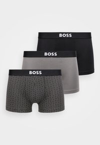 Három pár férfi boxeralsó. Színek: fekete, szürke és fekete-fehér pöttyös mintával. Mindegyiken fekete derékpánt látható, rajta "BOSS" logóval.