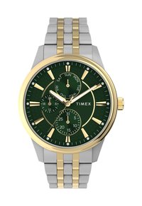 Timex watch with a green dial, gold and silver stainless steel case, three sub-dials, gold hour markers, and a textured background.