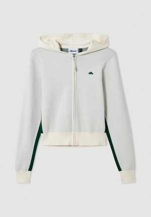 Lichtgrijze zip-up hoodie met crèmekleurige accenten, groene zijstrepen en een klein groen logo op de borst. Zachte textuur en een aansluitend ontwerp.