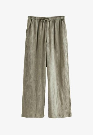 Pantaloni larghi verde chiaro realizzati in tessuto strutturato con cintura regolabile. Presentano una superficie sgualcita per un tocco di originalità.
