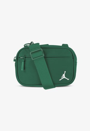Green fabric crossbody bag featuring a white Jumpman logo, adjustable strap, front zip pocket, and smooth texture. Compact rectangular design.