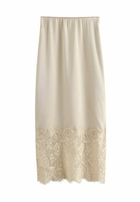 Kremowa spódnica do kolan z elastycznym pasem, ozdobiona delikatną koronką u dołu z motywem kwiatowym. Gładka faktura na całej powierzchni.