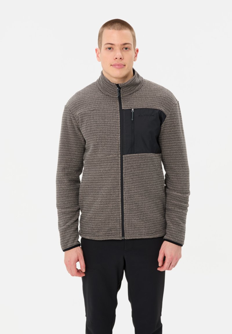 Fleece jacket in brown with a textured pattern. Features a black zippered chest pocket and zip front, high collar, and long sleeves.