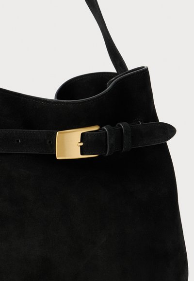 Black suede bag with a wide opening and a belt detail featuring a rectangular gold hardware buckle. Smooth texture with minimalistic design.