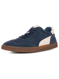 Navy blue suede sneaker with beige leather accents, brown rubber sole, and black laces in a low-top design angled to the right.