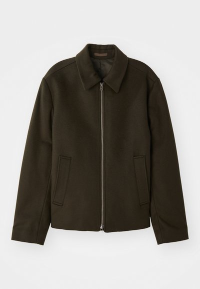 Dark green zip-up jacket made of a soft, textured fabric. Features a collar and two side pockets with a straightforward, minimalist design.