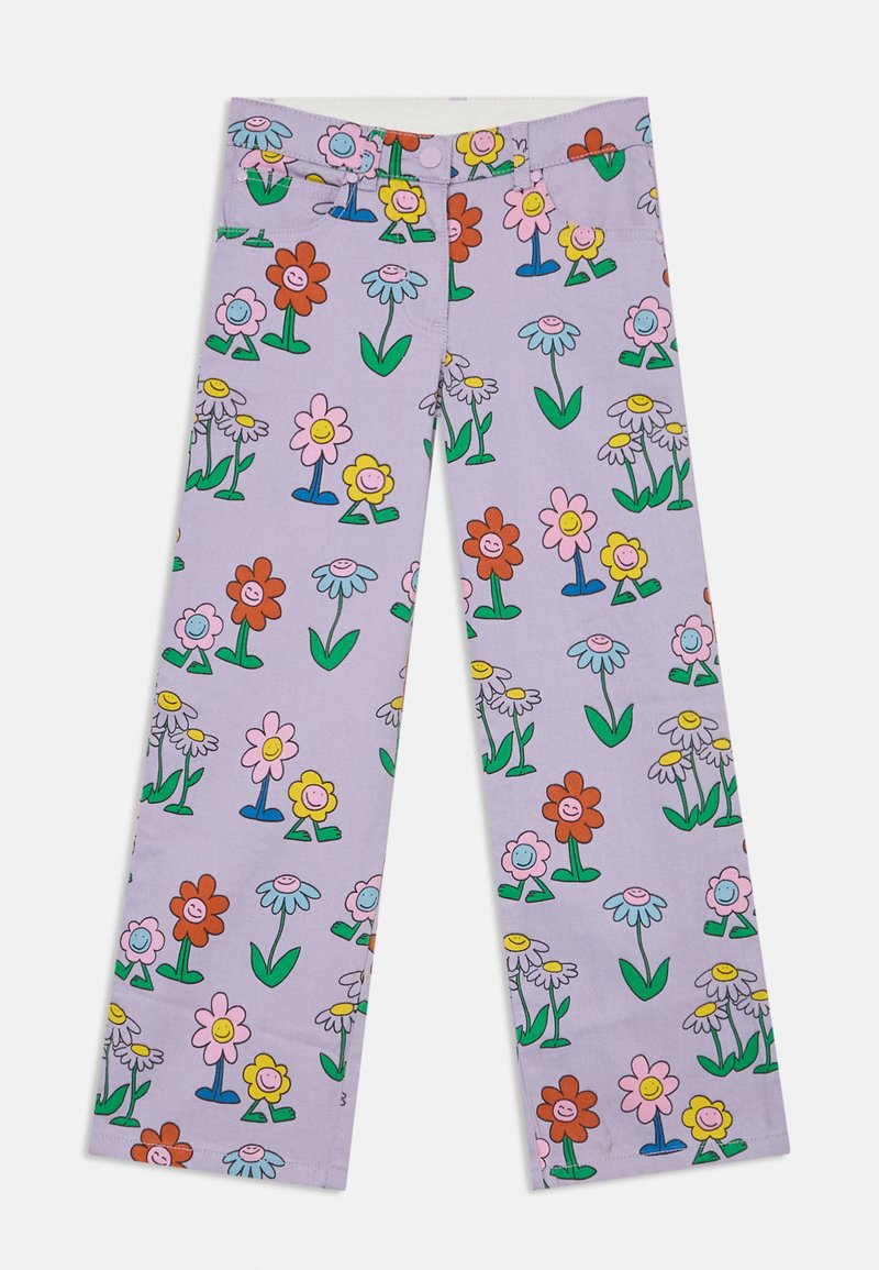 Lila vida byxor med ett färgglatt blommönster som visar leende blommor och gröna stjälkar. Tyget är mjukt med en slät textur.