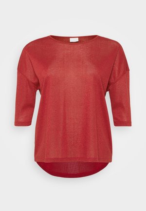 Sarkana īsām piedurknēm, brīvas formas, izgatavota no viegla, spīdīga auduma. Iezīmē noapaļotu kakla izgriezumu un noapaļotu apakšmali.