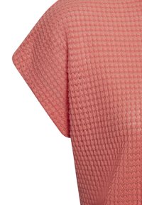 Textured coral shirt with a waffle-knit pattern, featuring short sleeves and a relaxed fit. Material appears lightweight and breathable.