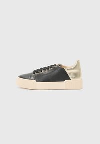 Black leather sneaker with a gold metallic accent, featuring a round toe, flat beige rubber sole, and round laces with gold eyelets.