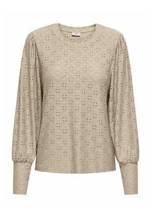 Beige langærmet top med struktureret stof og hulmønster, rund halsudskæring og samlede ærmer for volumen.