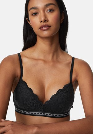 Schwarzer Spitzen-Bralette mit tiefem Ausschnitt, gewelltem Rand und verstellbaren Trägern. Mit einem dekorativen Band mit Logo am unteren Rand.