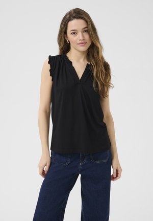 Haut sans manches noir avec des détails de manches à volants et un décolleté en V. Tissu doux avec une coupe décontractée. Associé à un jean large bleu foncé.