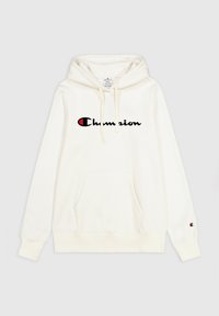 Sudadera color crema con capucha ajustable, bolsillo tipo canguro en la parte frontal y logo negro de "Champion" en el pecho. Mangas con puños y detalle del logo.
