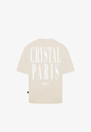Beżowy, oversize t-shirt z wyraźnym białym napisem na plecach: "CRYSTAL PARIS" i "DEPT.75" w nowoczesnej czcionce szeryfowej.