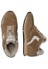 Suede sneakers in tan with white accents, featuring a lace-up design, plush lining, and a textured black rubber sole.