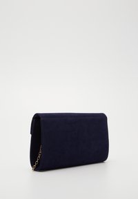 Clutch in suede blu navy con tracolla a catena, forma rettangolare, chiusura a pattina e dettagli di cucitura visibili. Texture liscia con finitura opaca.