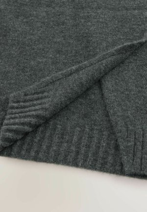 Dark gray wool fabric with soft texture, folded to reveal ribbed knit edge on a light surface.