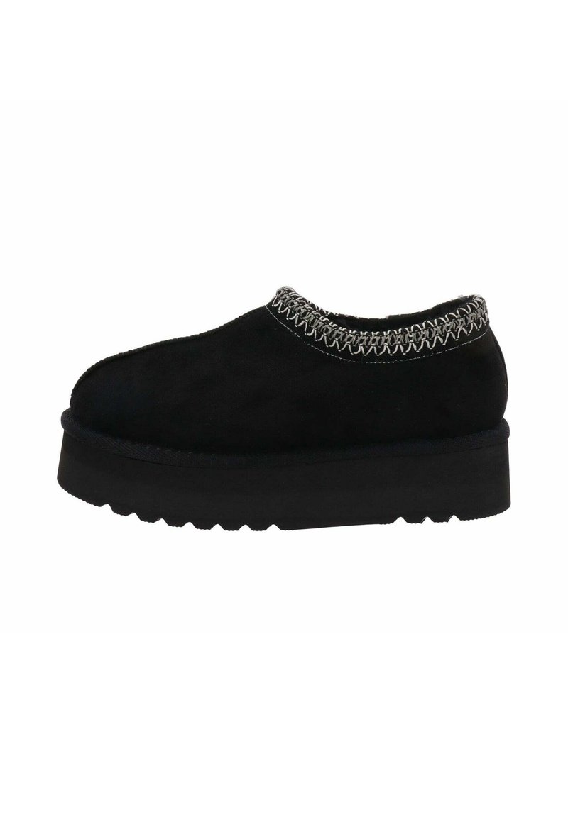 Zapatos de ante negro tipo slip-on con un detalle de costura texturizada alrededor del cuello y una suela gruesa y duradera con un patrón de zigzag.