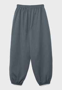 Luźne spodnie dresowe w ciemnoszarym kolorze, z elastycznym pasem i ściągaczami, zaprojektowane do codziennego noszenia.