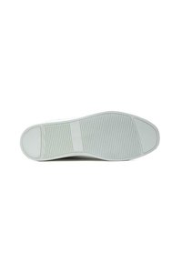 White rubber shoe sole featuring horizontal and vertical ridges for grip, with a smooth rounded toe and side accents for stability.