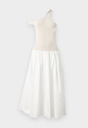 Asymmetrical one-shoulder dress in beige knit fabric with a flowing white cotton skirt. Features elastic waistband and gathered texture.