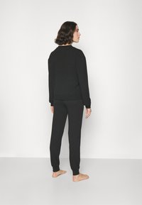 HUGO SPORTY LOGO PANTS - Pyjama bottoms - black