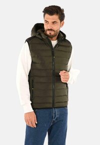 Gilet verde imbottito con zip frontale, cappuccio regolabile e due tasche con zip. Realizzato in materiale liscio e resistente all'acqua.