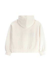 Skrócony, kremowy sweatshirt z kapturem. Posiada elastyczne mankiety oraz prosty design, wykonany z miękkiego, gładkiego materiału o matowym wykończeniu.