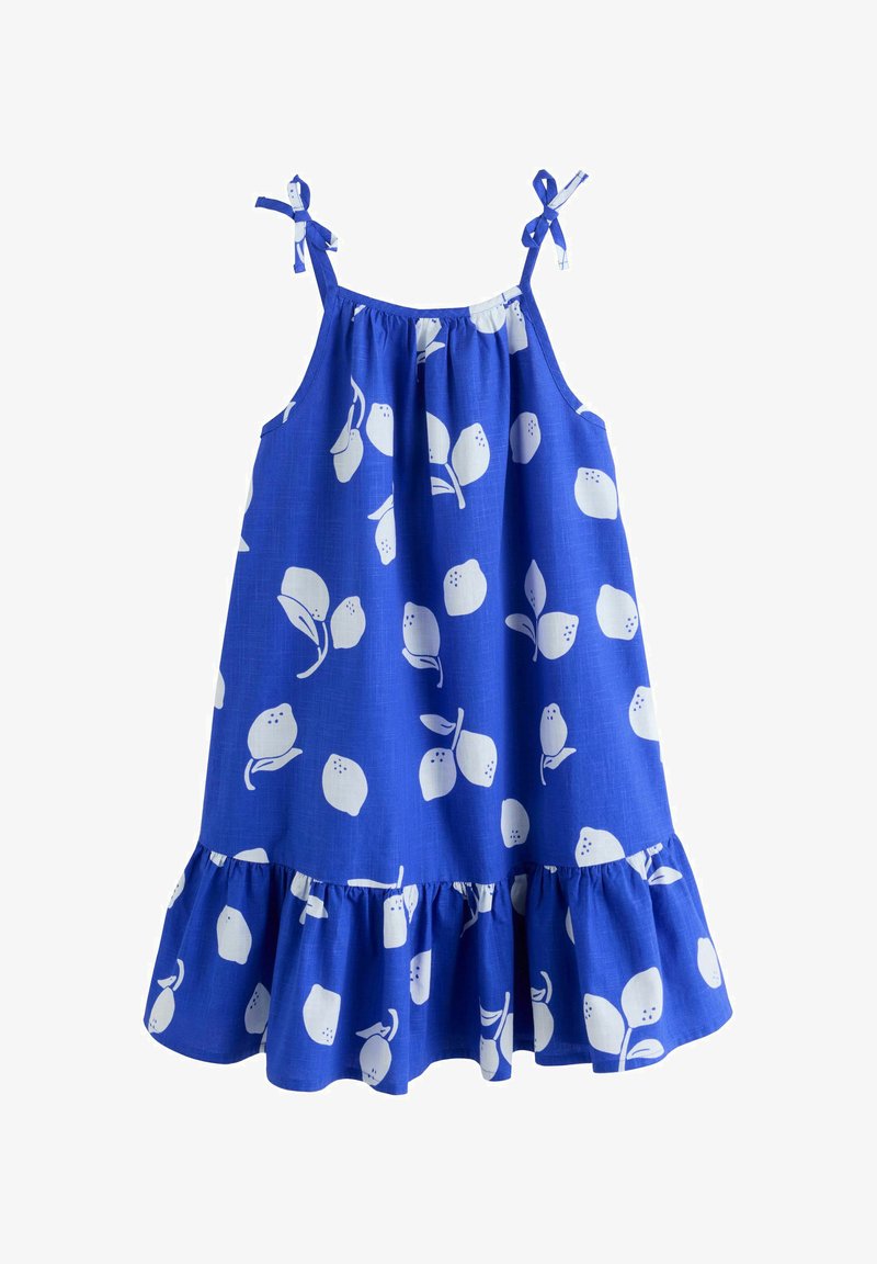 Robe bleue sans manches avec des imprimés de citrons blancs, des bretelles nouées aux épaules et un ourlet à volants.