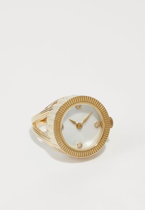 Gold-tone watch with a textured bezel, white dial, gold hands, and four sparkling accents. Features a split band design.