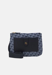 Navy and white patterned fabric bag with a smooth black leather front, gold accent hardware, and adjustable strap. Rectangular shape.