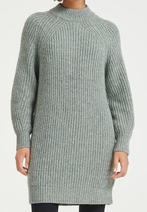 Pull à manches longues et col montant en maille côtelée douce. Couleur vert clair avec un motif texturé et une silhouette décontractée.