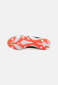 Sole di scarpa sportiva in bianco e nero con un vivace accento arancione. Presenta più impugnature testurizzate e un design aerodinamico.