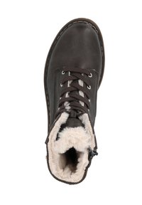 Brown leather ankle boot with white faux fur lining, round toe, and black laces. Detailed stitching along the sole. Low-profile design.