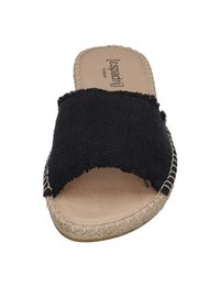 Black fabric slide sandals with a wide crisscross design, frayed edges, and a natural, textured sole featuring contrasting stitching.