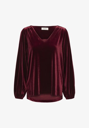 Burgundy sammetstop med långa puffärmar, V-ringning och en något längre bakre fåll. Mjuk textur med en slät, blank yta.