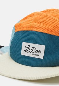 Colorful corduroy cap featuring an orange top, teal sides, and a cream brim. Includes a white label with "Lil' Boo Copenhagen" text.